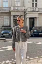 a lady in a grey double-breasred coat